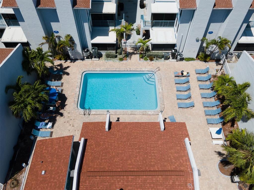 171 Medallion Boulevard, Unit F Madeira Beach, FL 33708 - Photo 22 of 30 a vase of flowers sitting on a table