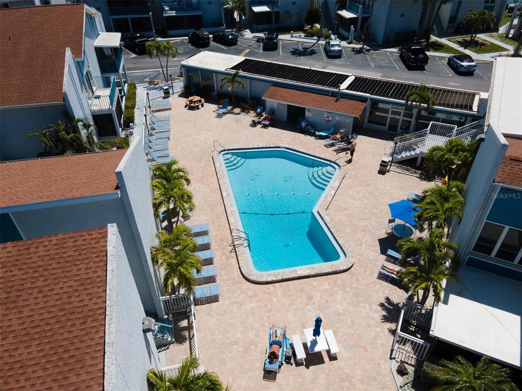171 Medallion Boulevard, Unit F Madeira Beach, FL 33708 - Photo 23 of 30 an aerial view of a house with garden space and swimming pool