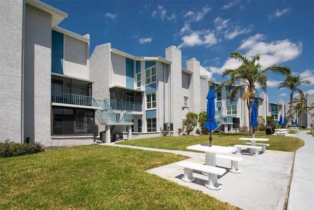 a view of a swimming pool with outdoor seating and plants