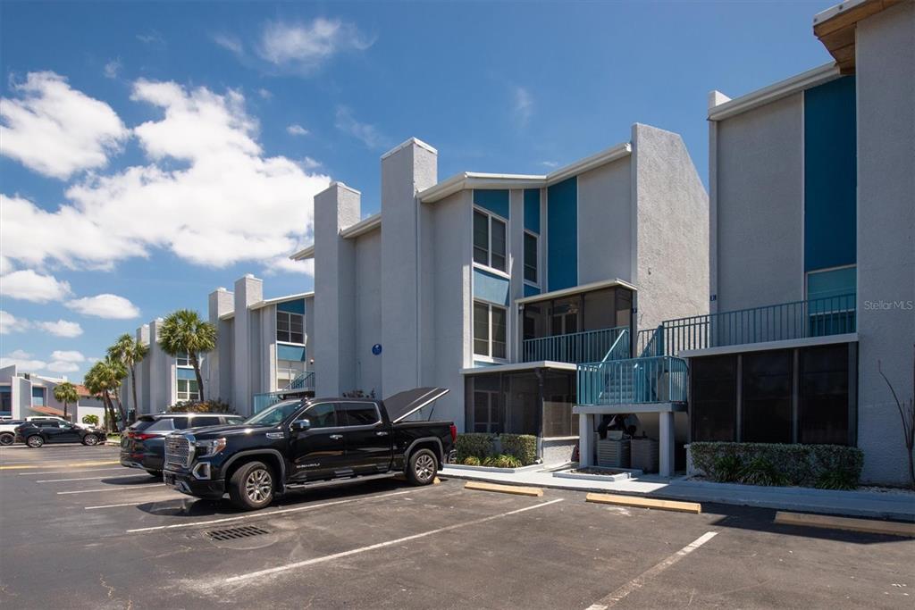 171 Medallion Boulevard, Unit F Madeira Beach, FL 33708 - Photo 29 of 30 a car parked in front of a building