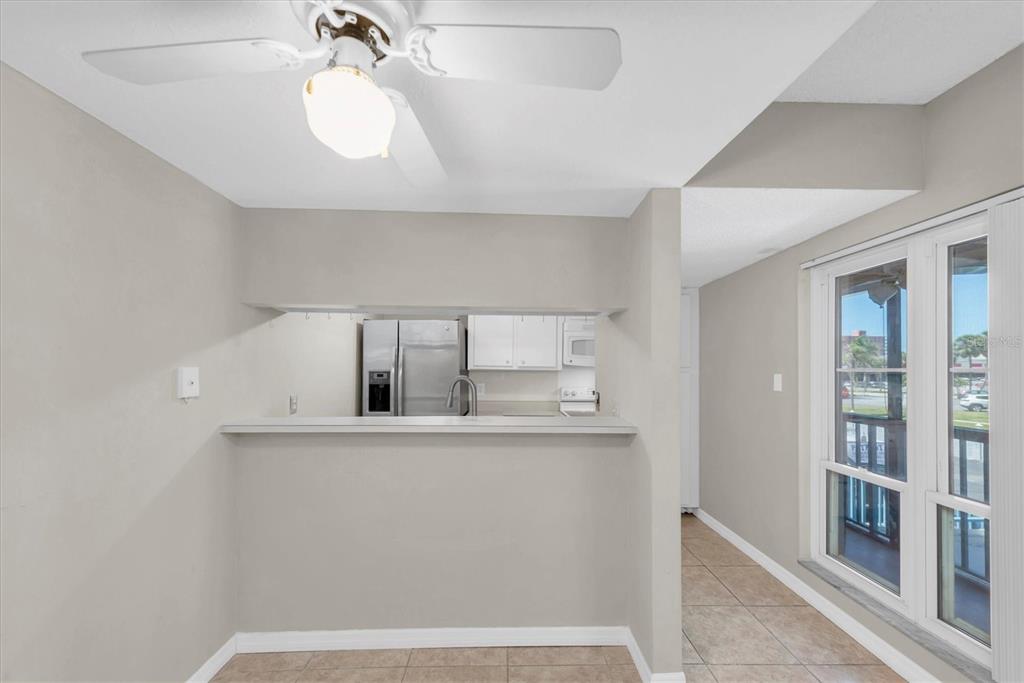 171 Medallion Boulevard, Unit F Madeira Beach, FL 33708 - Photo 8 of 30 a room with kitchen island a stove a chimney and a sink