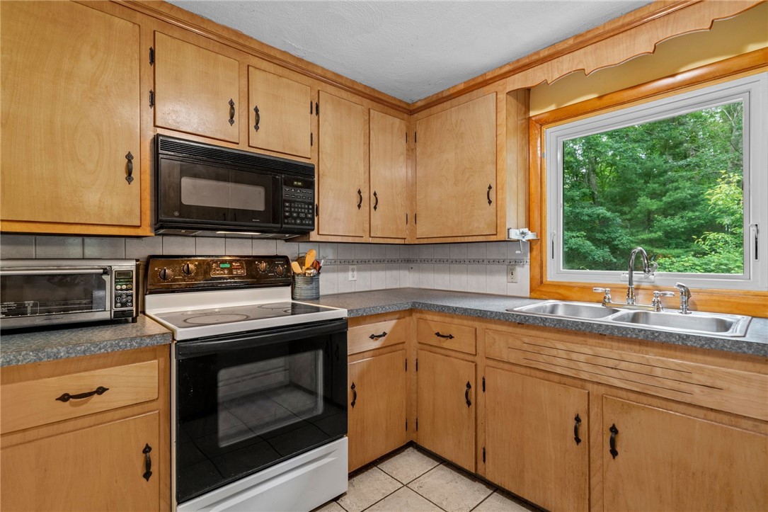 252 Log Bridge Road Coventry, RI 02816 - Photo 13 of 36 Roomy kitchen overlooking the serene backyard and woods