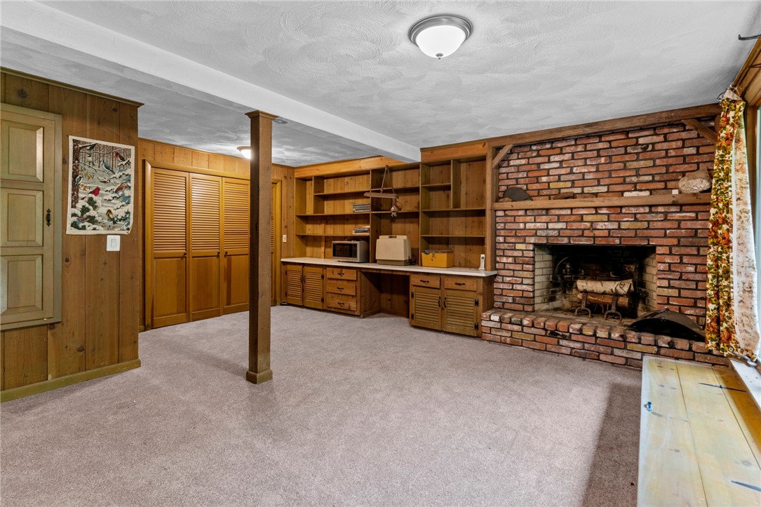 252 Log Bridge Road Coventry, RI 02816 - Photo 26 of 36 Finished walk-out basement with fireplace, large storage closets, built in bookshelves and cabinets and half bath/utility room . Brand new carpet!