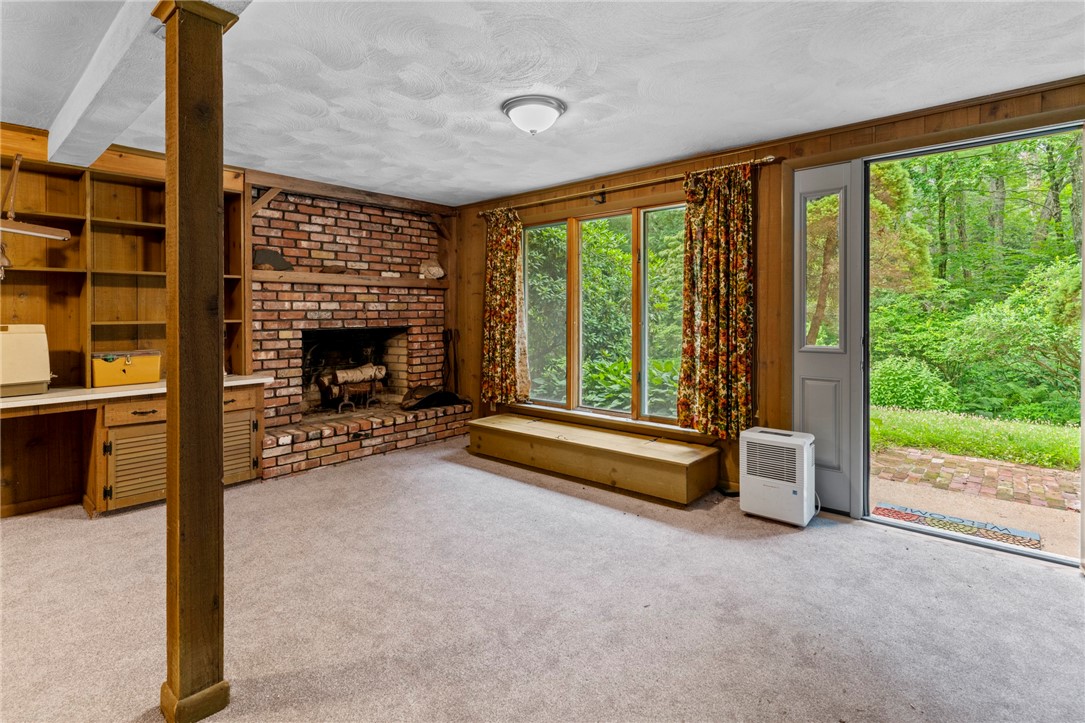 252 Log Bridge Road Coventry, RI 02816 - Photo 27 of 36 Finished walk-out basement with fireplace, large storage closets, built in bookshelves and cabinets and half bath/utility room . Brand new carpet!