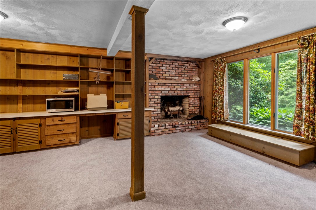 252 Log Bridge Road Coventry, RI 02816 - Photo 28 of 36 Finished walk-out basement with fireplace, large storage closets, built in bookshelves and cabinets and half bath/utility room . Brand new carpet!