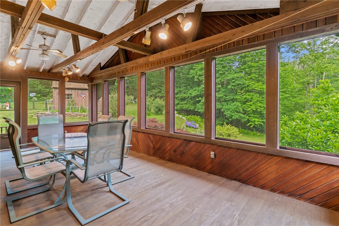 252 Log Bridge Road Coventry, RI 02816 - Photo 9 of 36 Sit out and enjoy a beautiful summer night or coffee in the morning! This enclosed porch offers tons of extra space and could easily be finished for extra living space!