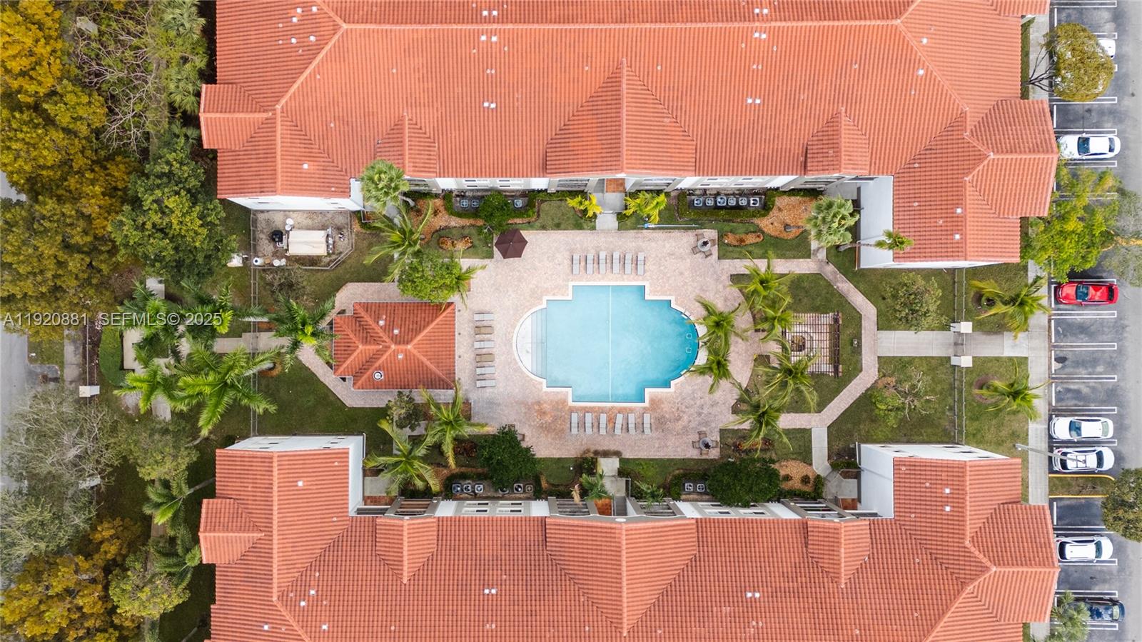 an aerial view of a house with a garden and outdoor seating