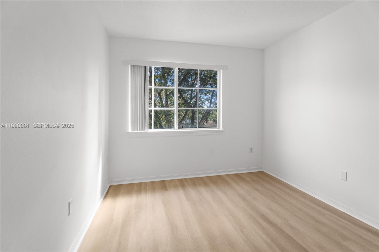 6821 Southwest 44th Street, Unit 203 Miami, FL 33155 - Photo 15 of 28 an empty room with a window