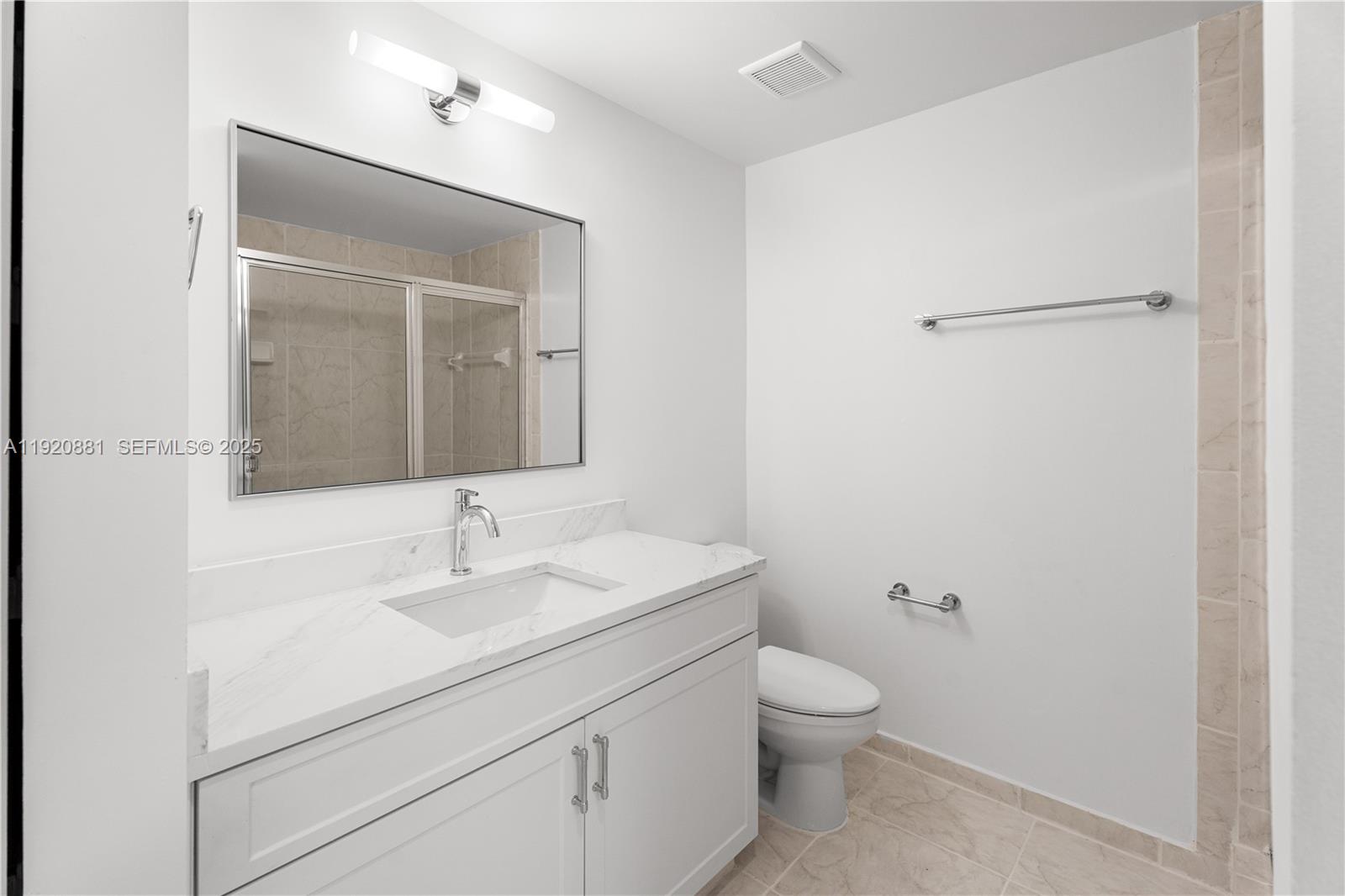 6821 Southwest 44th Street, Unit 203 Miami, FL 33155 - Photo 17 of 28 a bathroom with a toilet sink and mirror