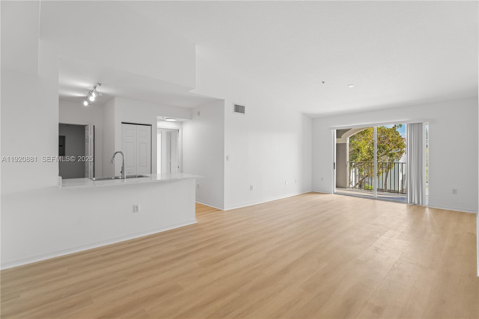6821 Southwest 44th Street, Unit 203 Miami, FL 33155 - Photo 7 of 28 a view of an empty room with window and wooden floor