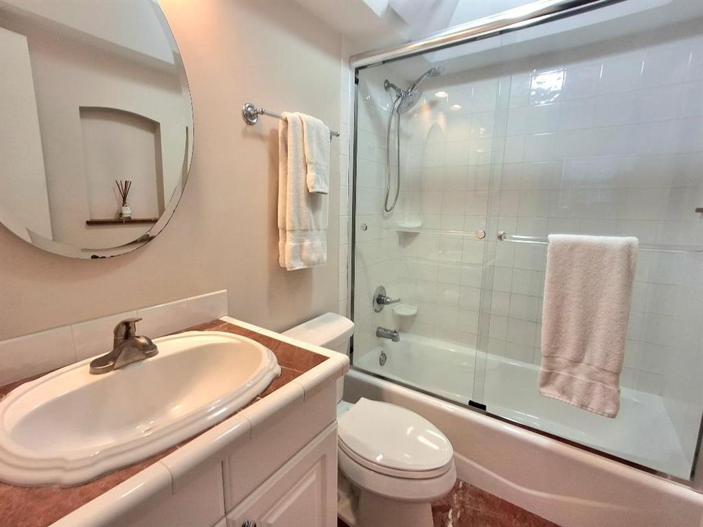 1421 South Ocean Boulevard, Unit 318 Pompano Beach, FL 33062 - Photo 15 of 36 a bathroom with a sink toilet and shower