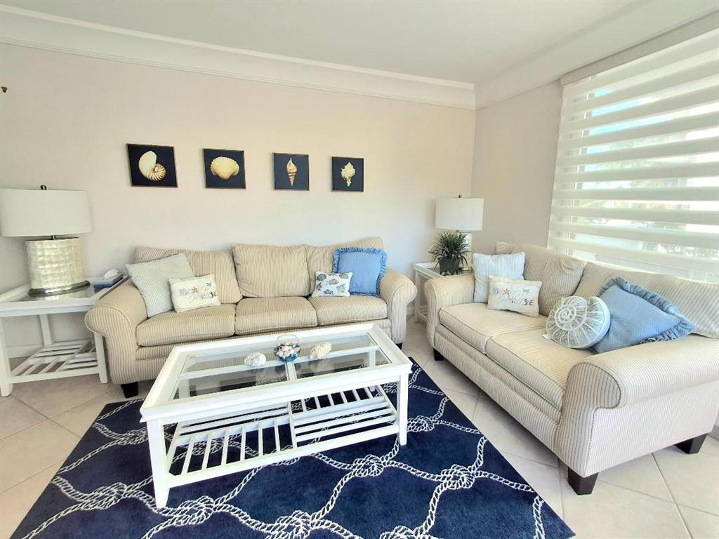 1421 South Ocean Boulevard, Unit 318 Pompano Beach, FL 33062 - Photo 3 of 36 a living room with furniture and a rug