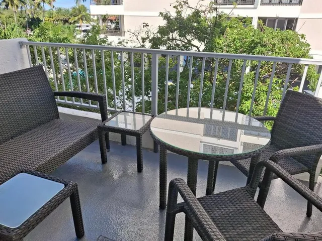 a view of a chairs and table in the balcony