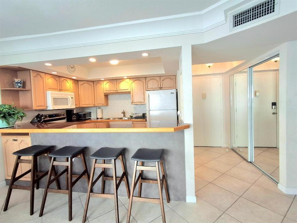 1421 South Ocean Boulevard, Unit 318 Pompano Beach, FL 33062 - Photo 10 of 36 a room with granite countertop a counter space and view of living room