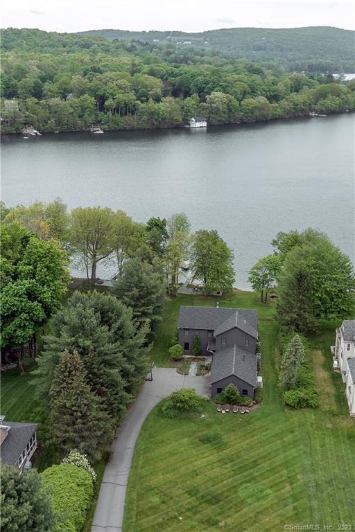 an aerial view of a house with pool and a yard