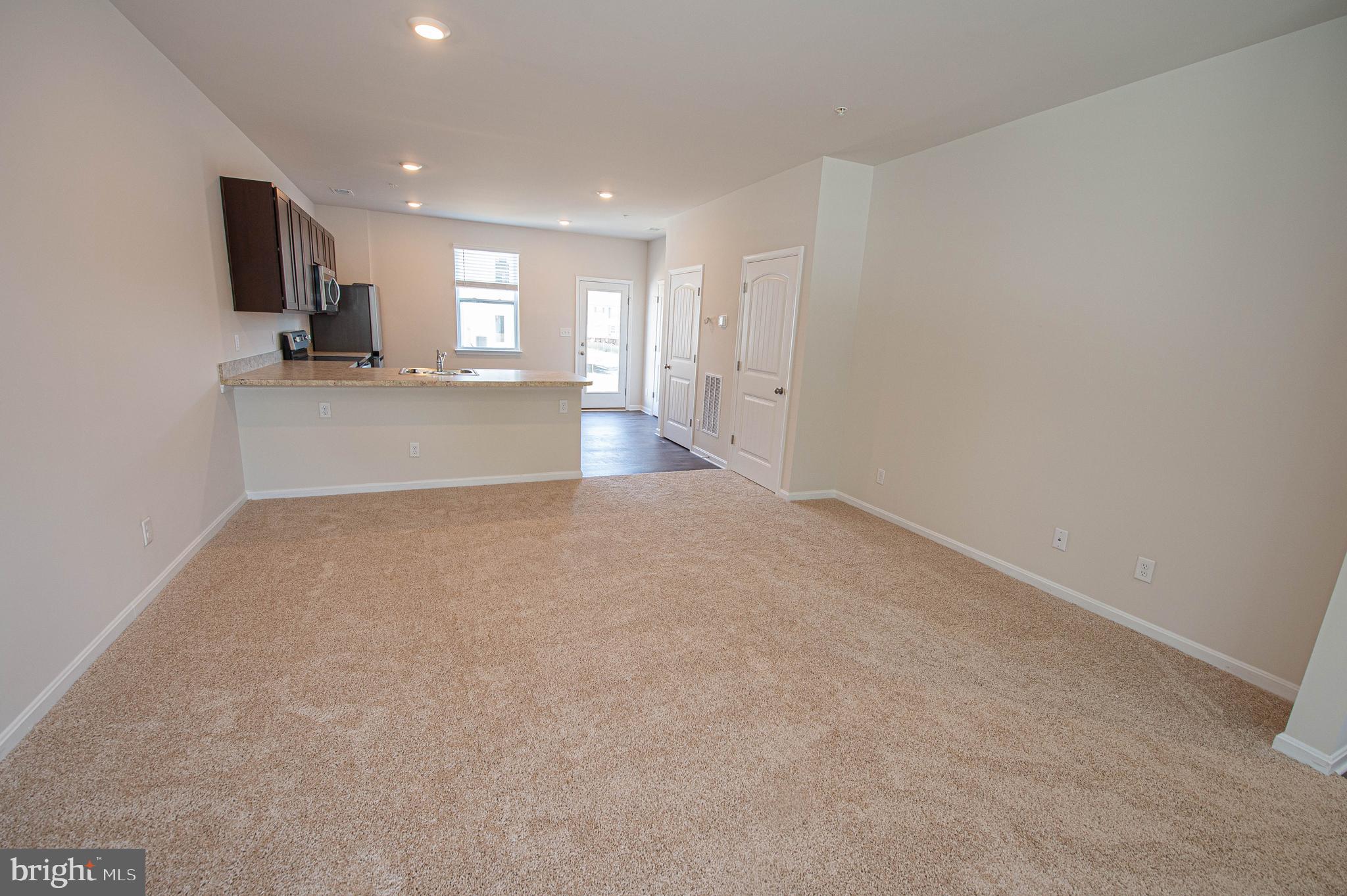 126 Willowtree Lane Fruitland, MD 21826 - Photo 18 of 68 a view of kitchen with kitchen island microwave and cabinets