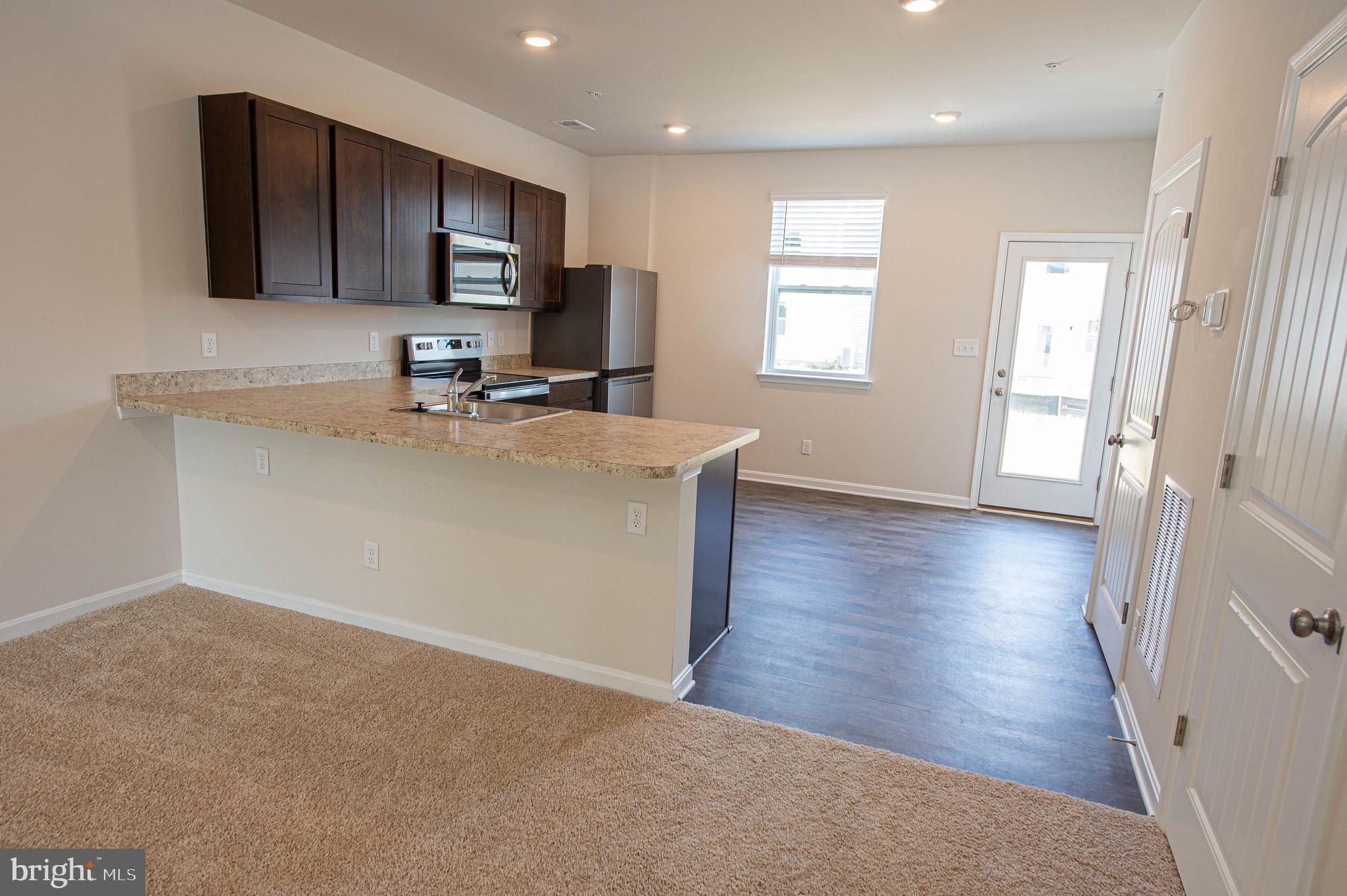 126 Willowtree Lane Fruitland, MD 21826 - Photo 22 of 68 a kitchen with stainless steel appliances granite countertop a sink stove and refrigerator