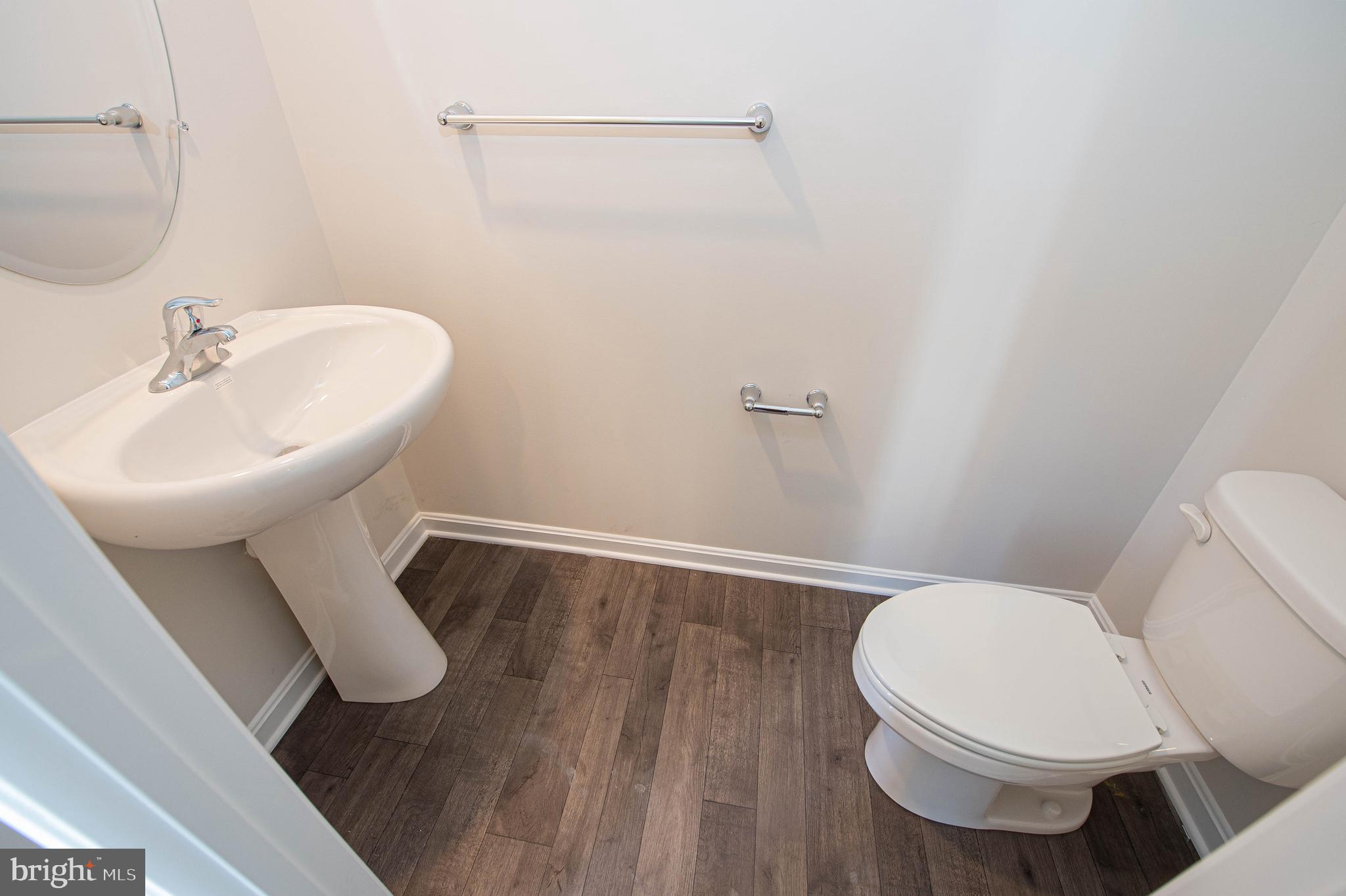 126 Willowtree Lane Fruitland, MD 21826 - Photo 29 of 68 a white toilet sitting next to a bathroom sink