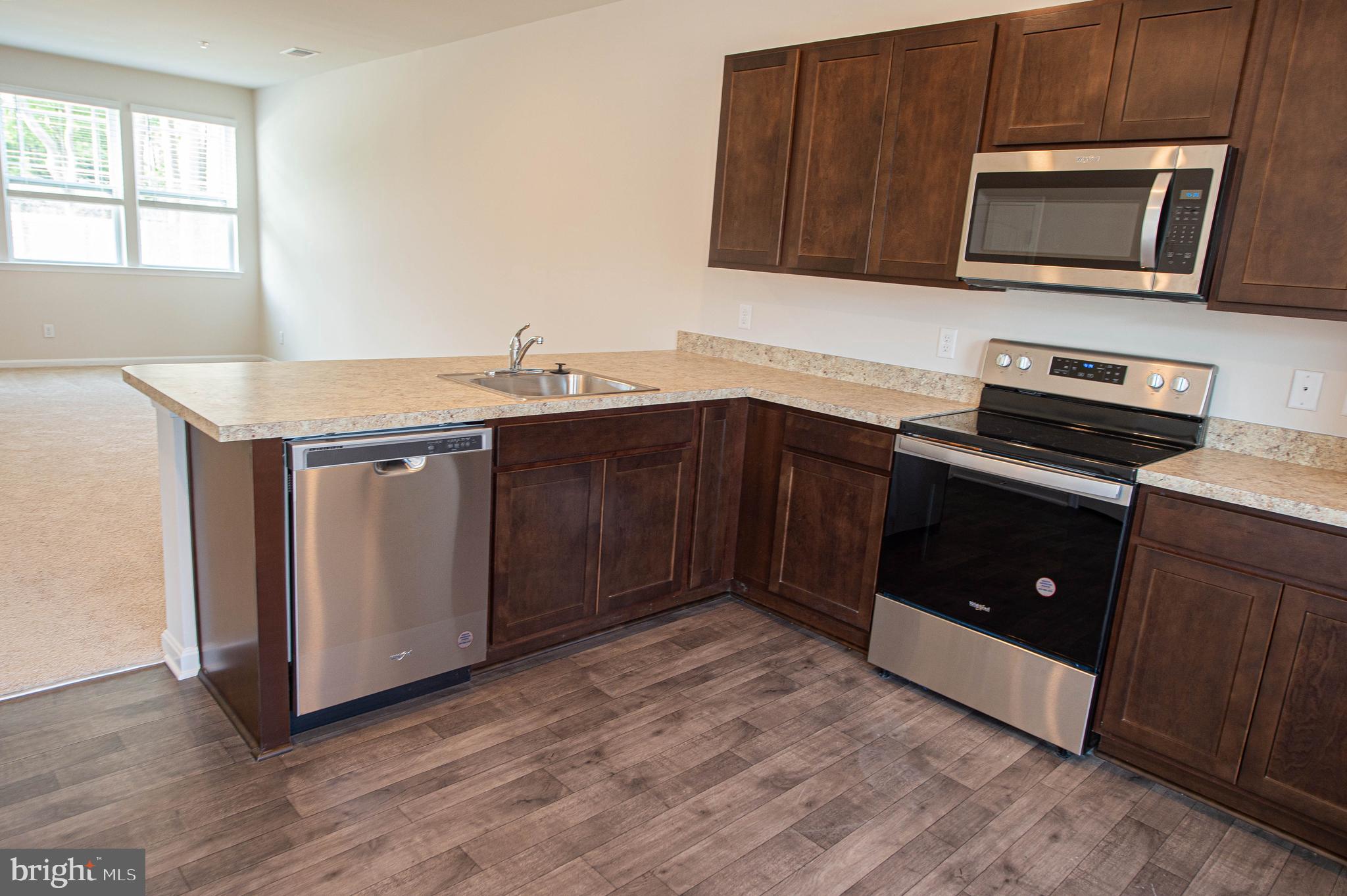 126 Willowtree Lane Fruitland, MD 21826 - Photo 32 of 68 a kitchen with a stove microwave and sink