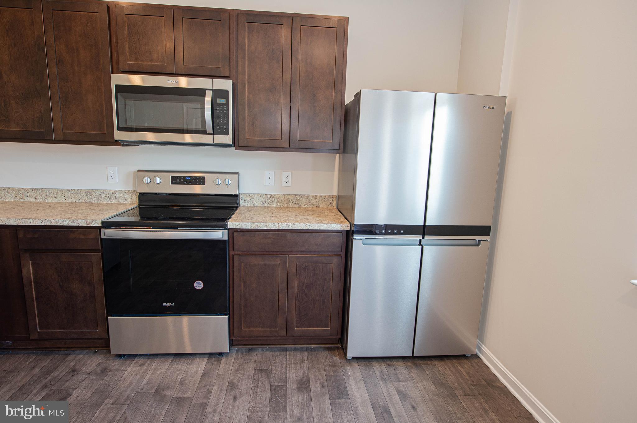 126 Willowtree Lane Fruitland, MD 21826 - Photo 33 of 68 a kitchen with wooden cabinets and stainless steel appliances
