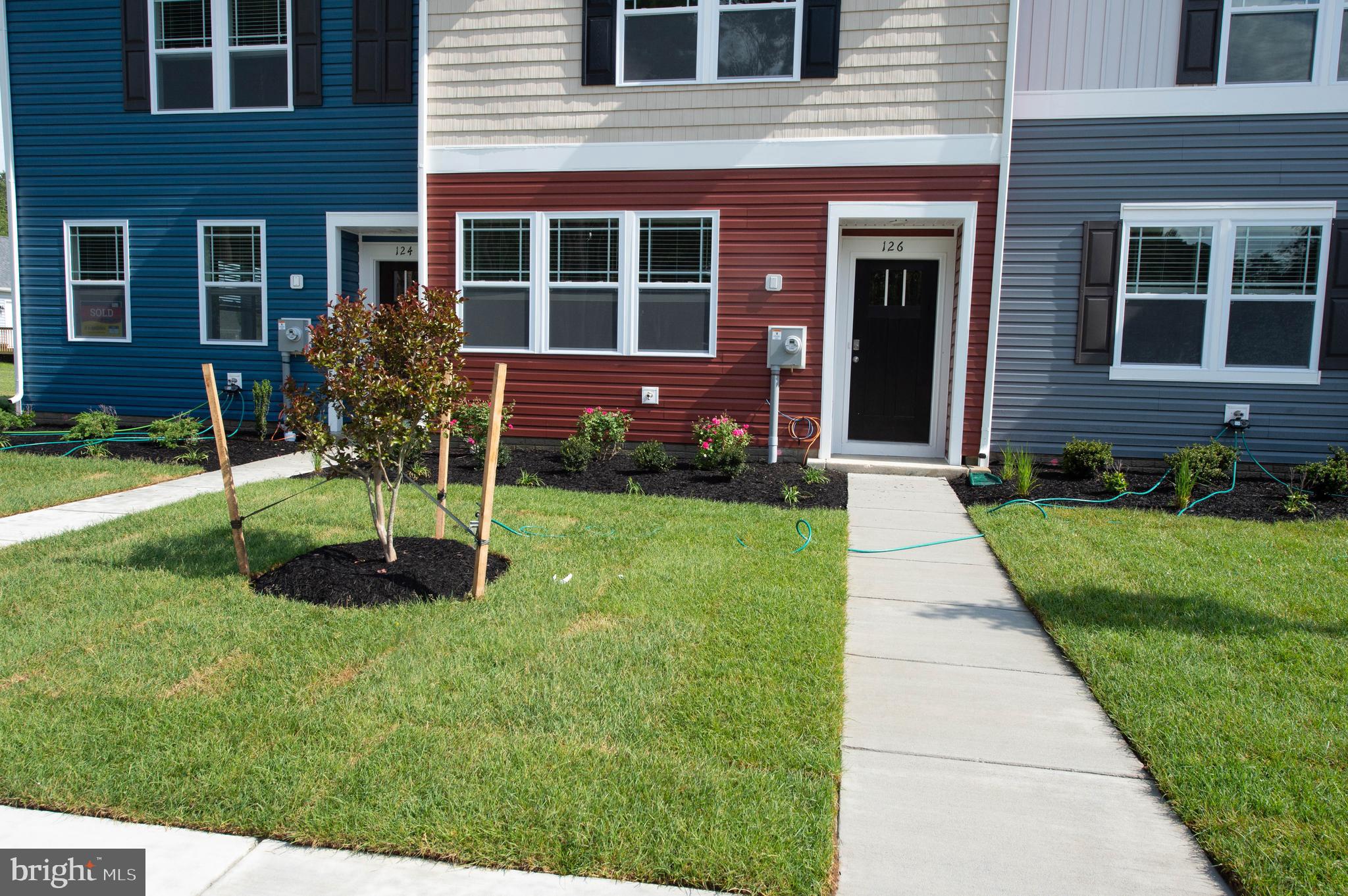 126 Willowtree Lane Fruitland, MD 21826 - Photo 4 of 68 a view of a brick house with a yard and large tree
