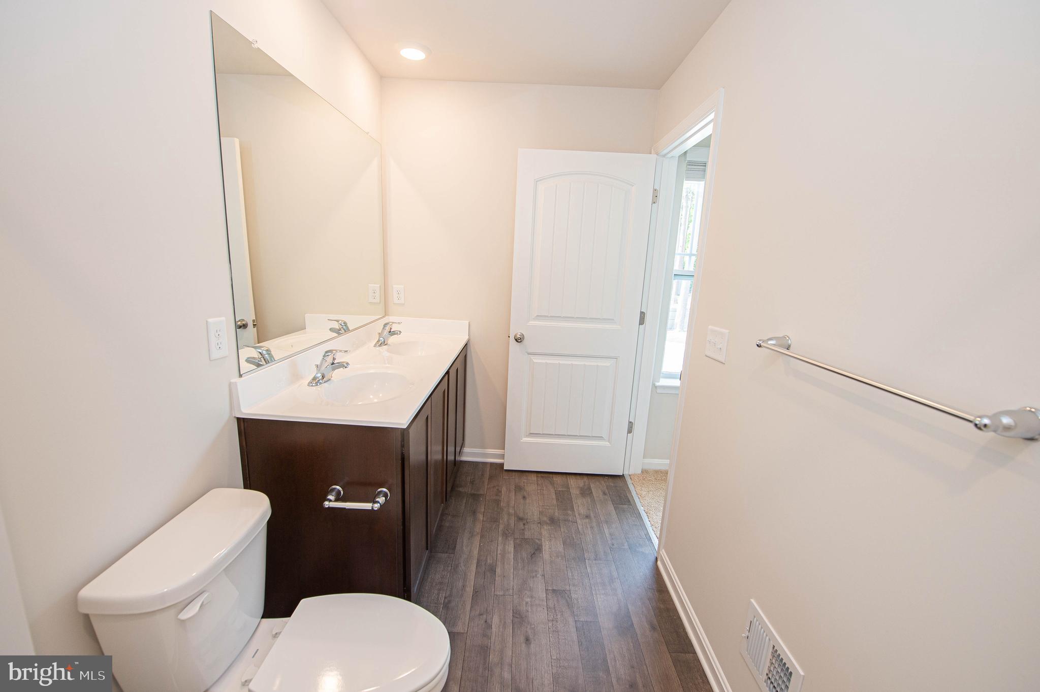 126 Willowtree Lane Fruitland, MD 21826 - Photo 55 of 68 a bathroom with a sink toilet and mirror