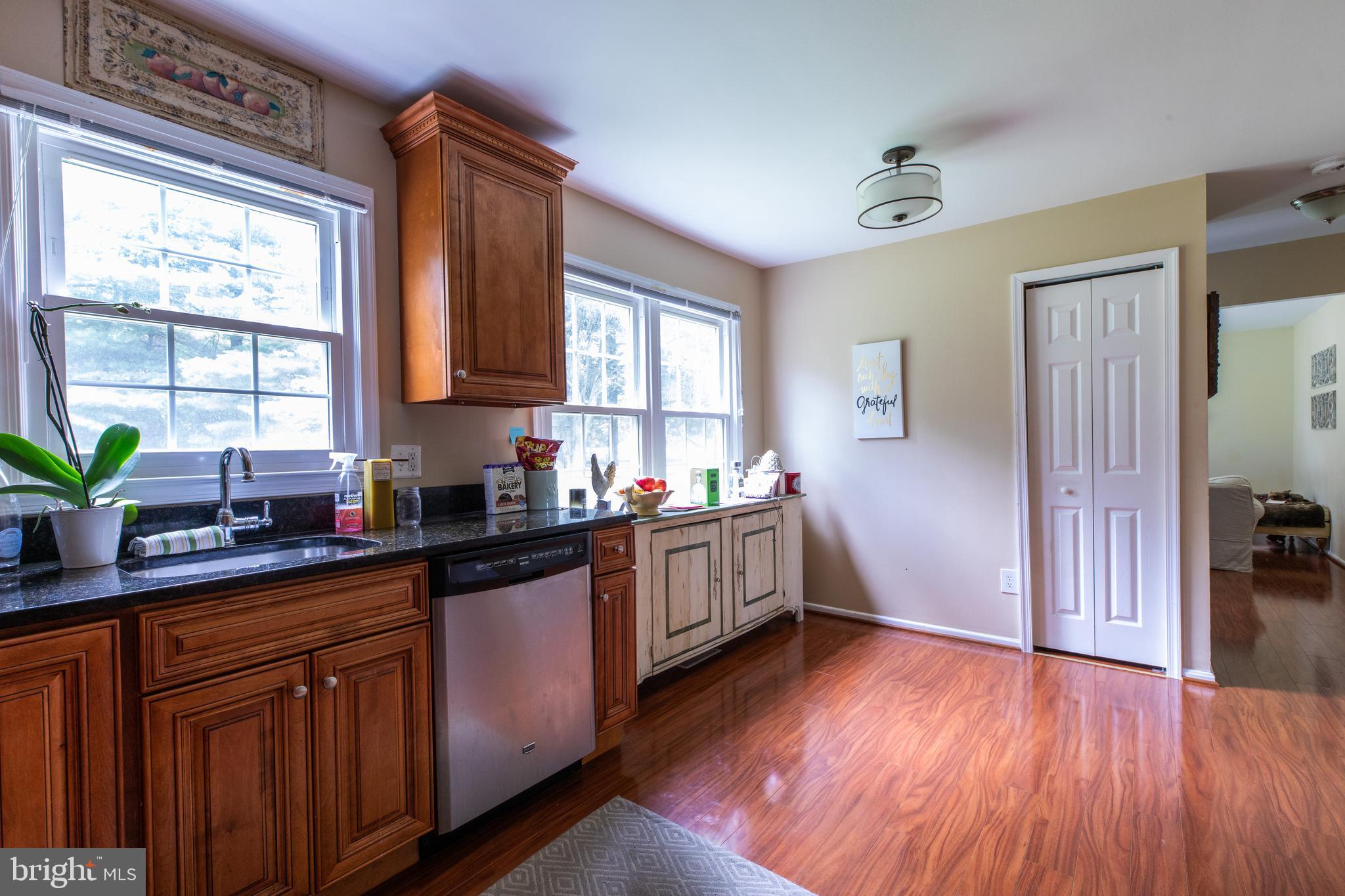 2527 Lindley Terrace Rockville, MD 20850 - Photo 11 of 31 a kitchen with granite countertop wooden floors and sink
