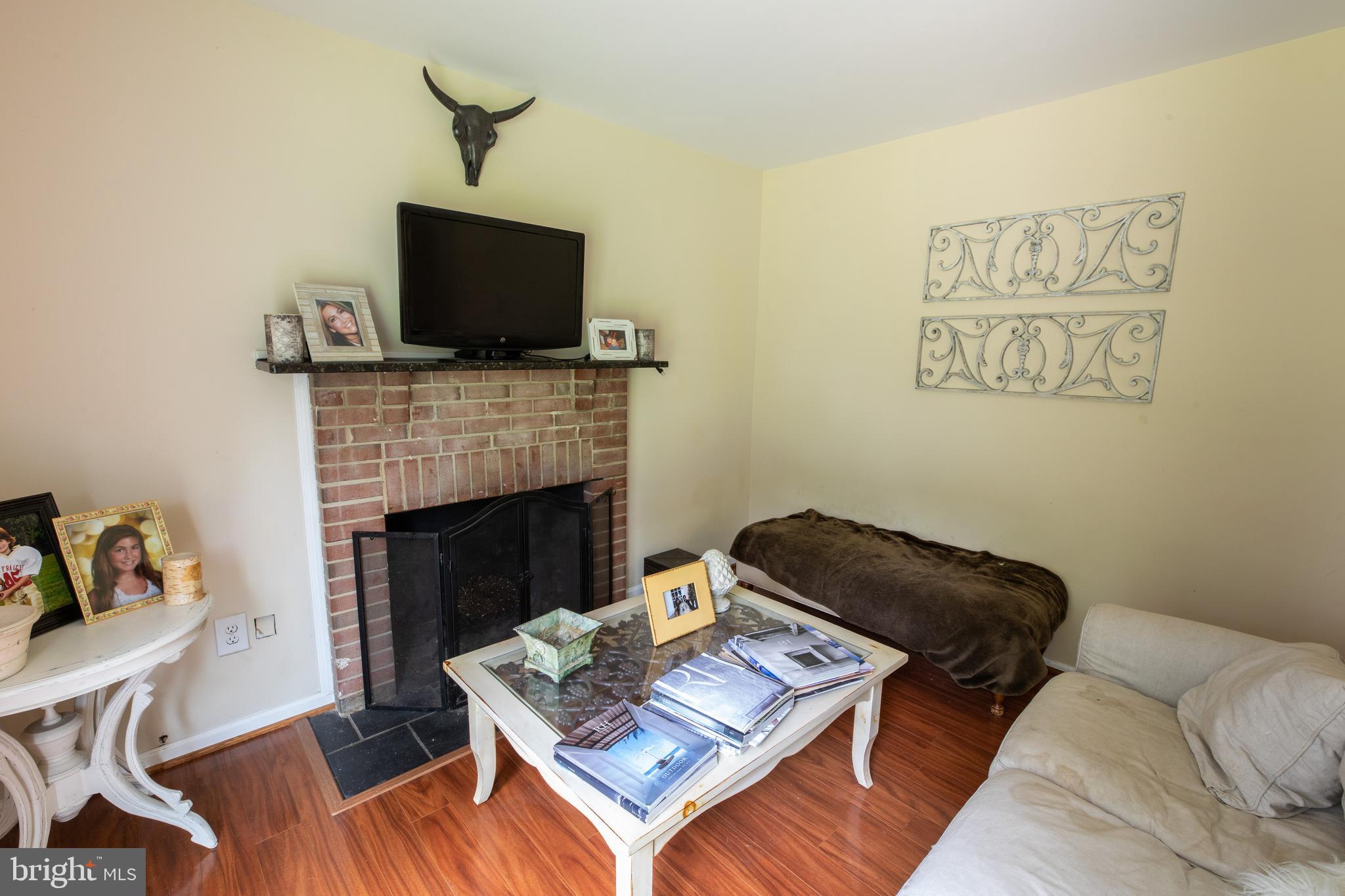 2527 Lindley Terrace Rockville, MD 20850 - Photo 13 of 31 a living room with furniture and a fireplace