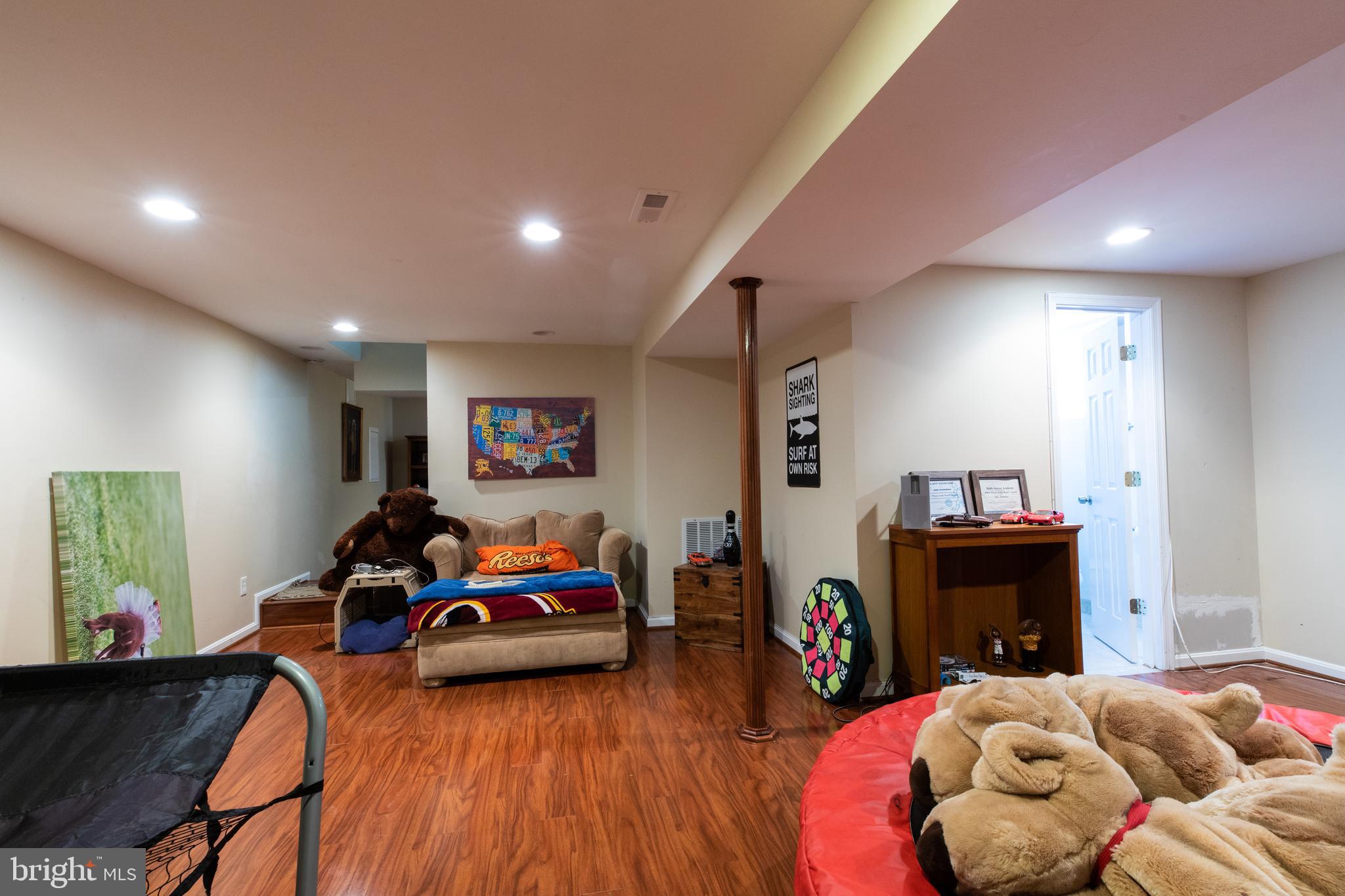 2527 Lindley Terrace Rockville, MD 20850 - Photo 22 of 31 a bedroom with furniture and a wooden floor