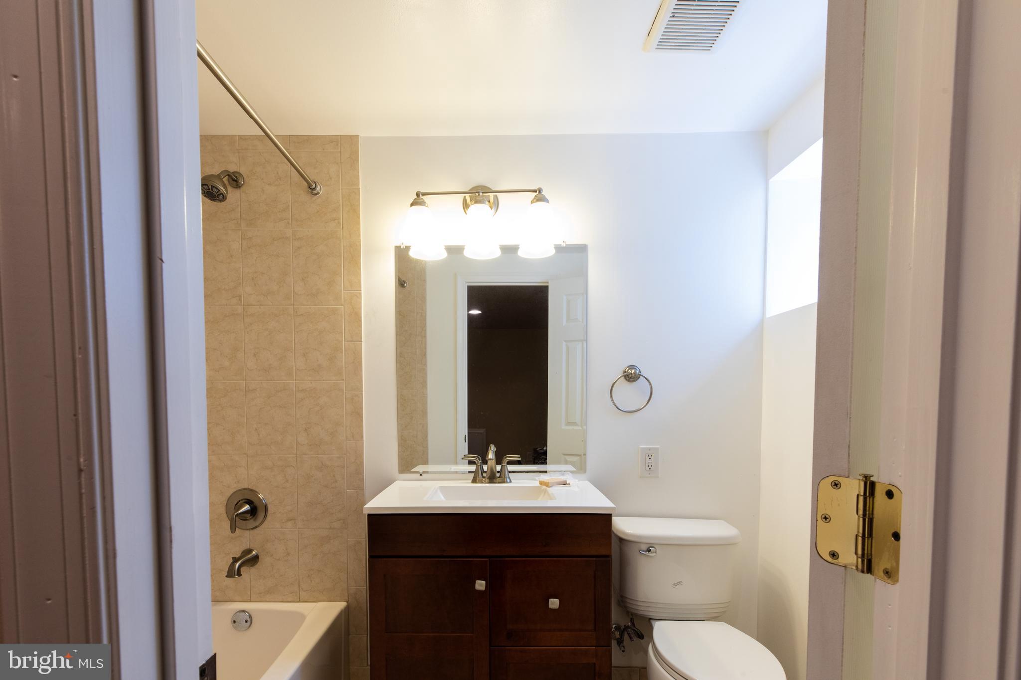 2527 Lindley Terrace Rockville, MD 20850 - Photo 24 of 31 a bathroom with a sink a toilet and shower