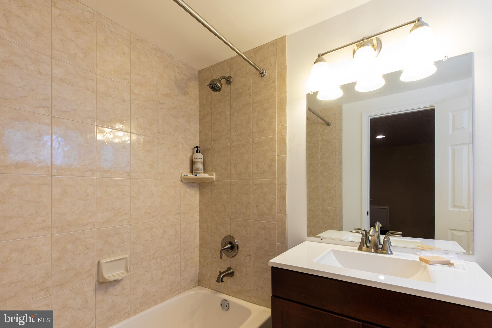 2527 Lindley Terrace Rockville, MD 20850 - Photo 25 of 31 a bathroom with a sink a toilet and shower