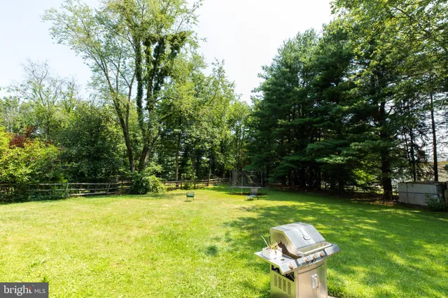 a swimming pool with outdoor seating and yard