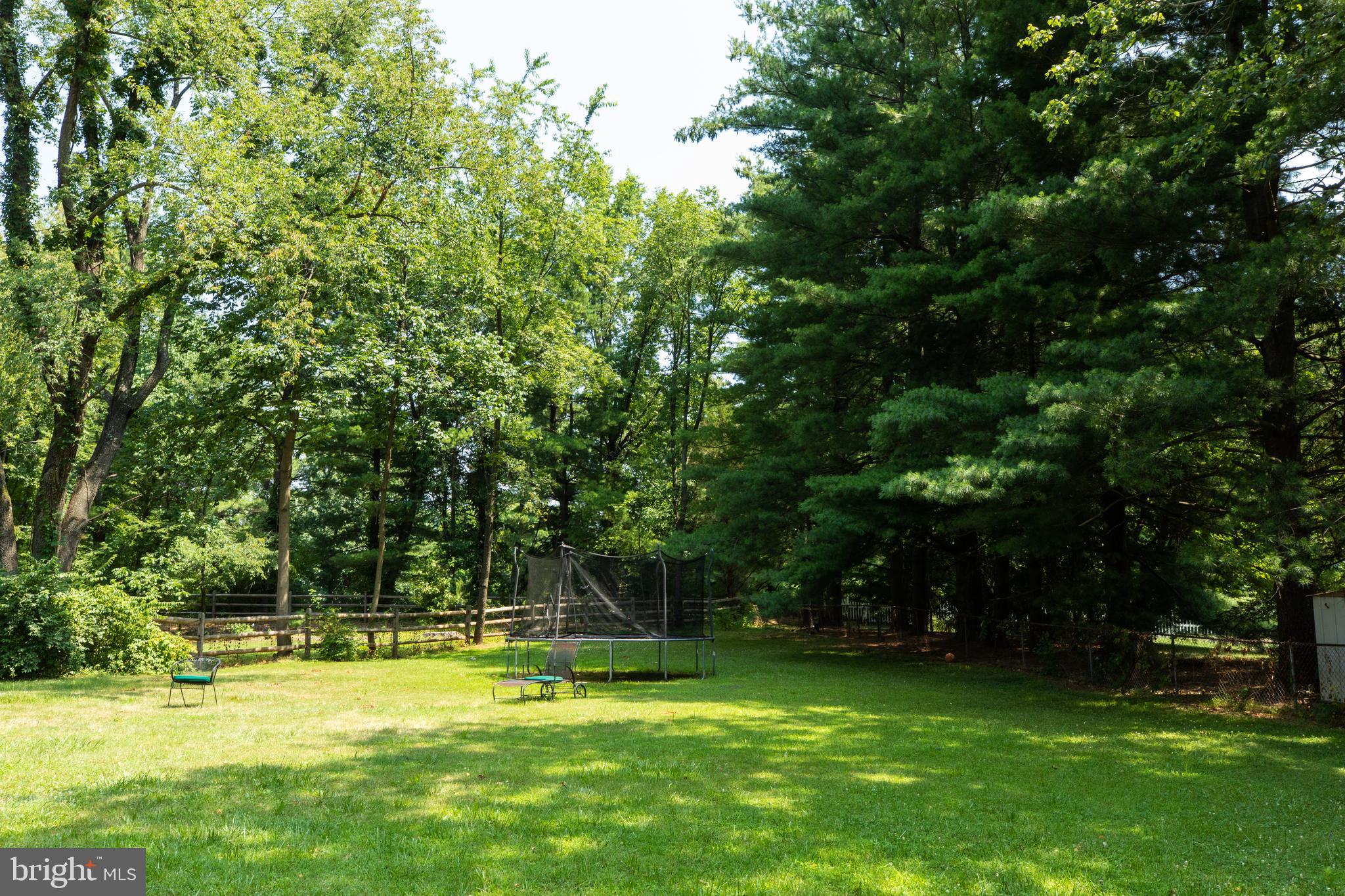 2527 Lindley Terrace Rockville, MD 20850 - Photo 29 of 31 a view of a swimming pool with a big yard and large trees