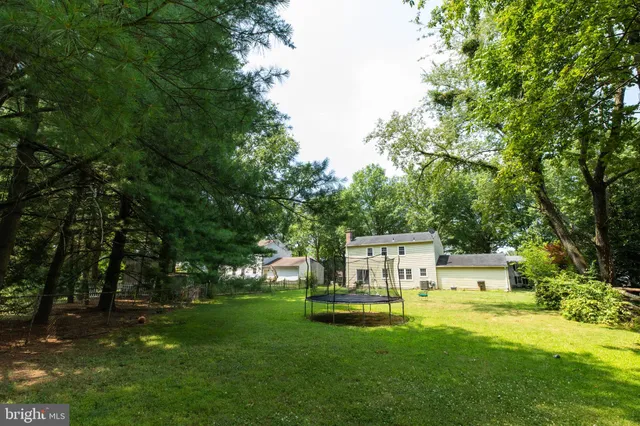 a view of a house with backyard sitting area and garden