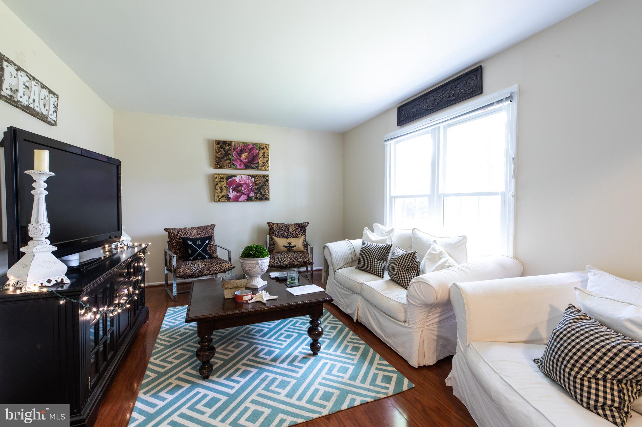 2527 Lindley Terrace Rockville, MD 20850 - Photo 4 of 31 a living room with furniture and a flat screen tv