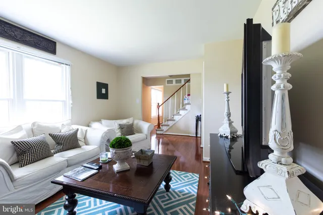 a living room with furniture a rug and a window