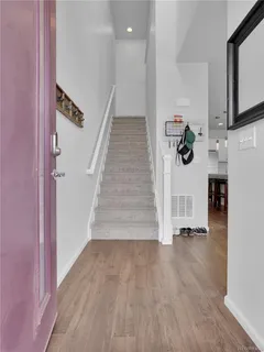 a view of entryway and hall with wooden floor
