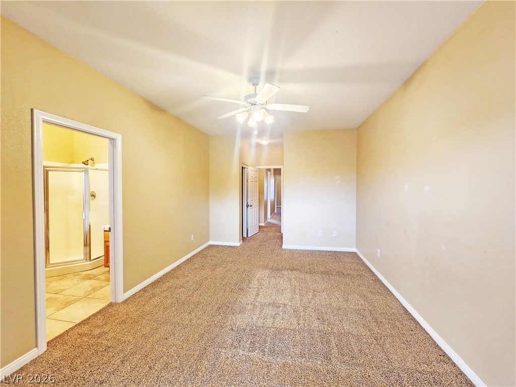 1421 Star Road, Unit 2 Pahrump, NV 89048 - Photo 24 of 33 Unfurnished room featuring baseboards, ceiling fan, and light carpet