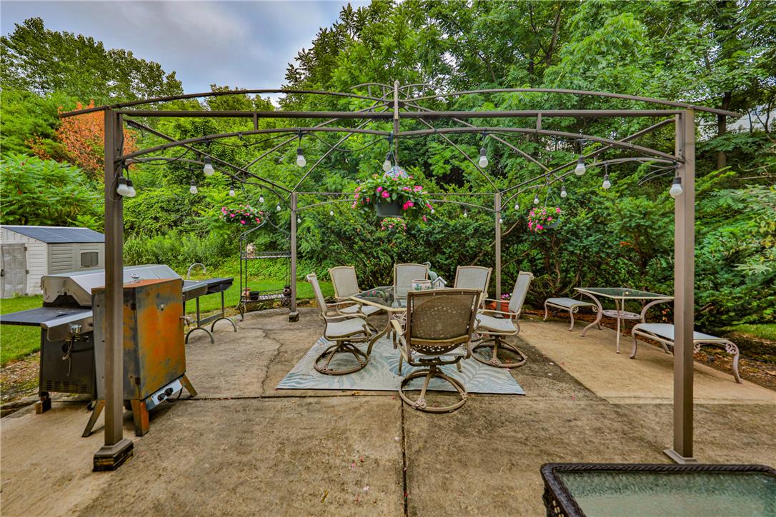 138 Clover Hollow Road Easton, PA 18045 - Photo 81 of 95 An inviting outdoor living area, shaded by a stylish metal pergola, awaits al fresco dining.