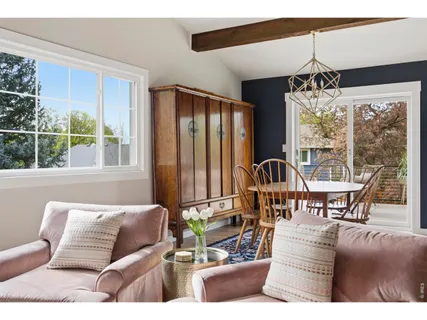 a living room with furniture and floor to ceiling windows