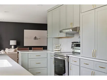 a kitchen with stainless steel appliances a sink a stove and a refrigerator