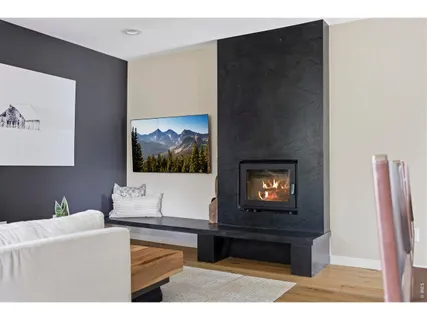 a living room with furniture and a painting on the wall