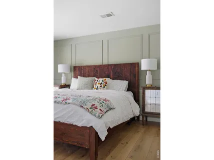 a bedroom with a bed and a lamp