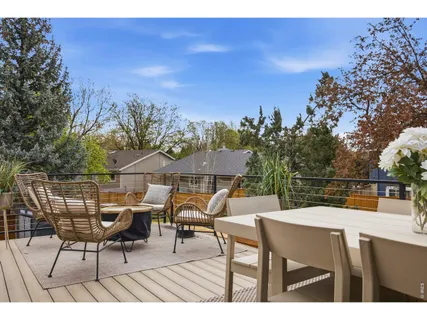 a balcony with table and chairs