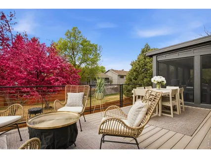 a backyard of a house with table and chairs