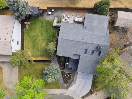 a backyard of a house with table and chairs
