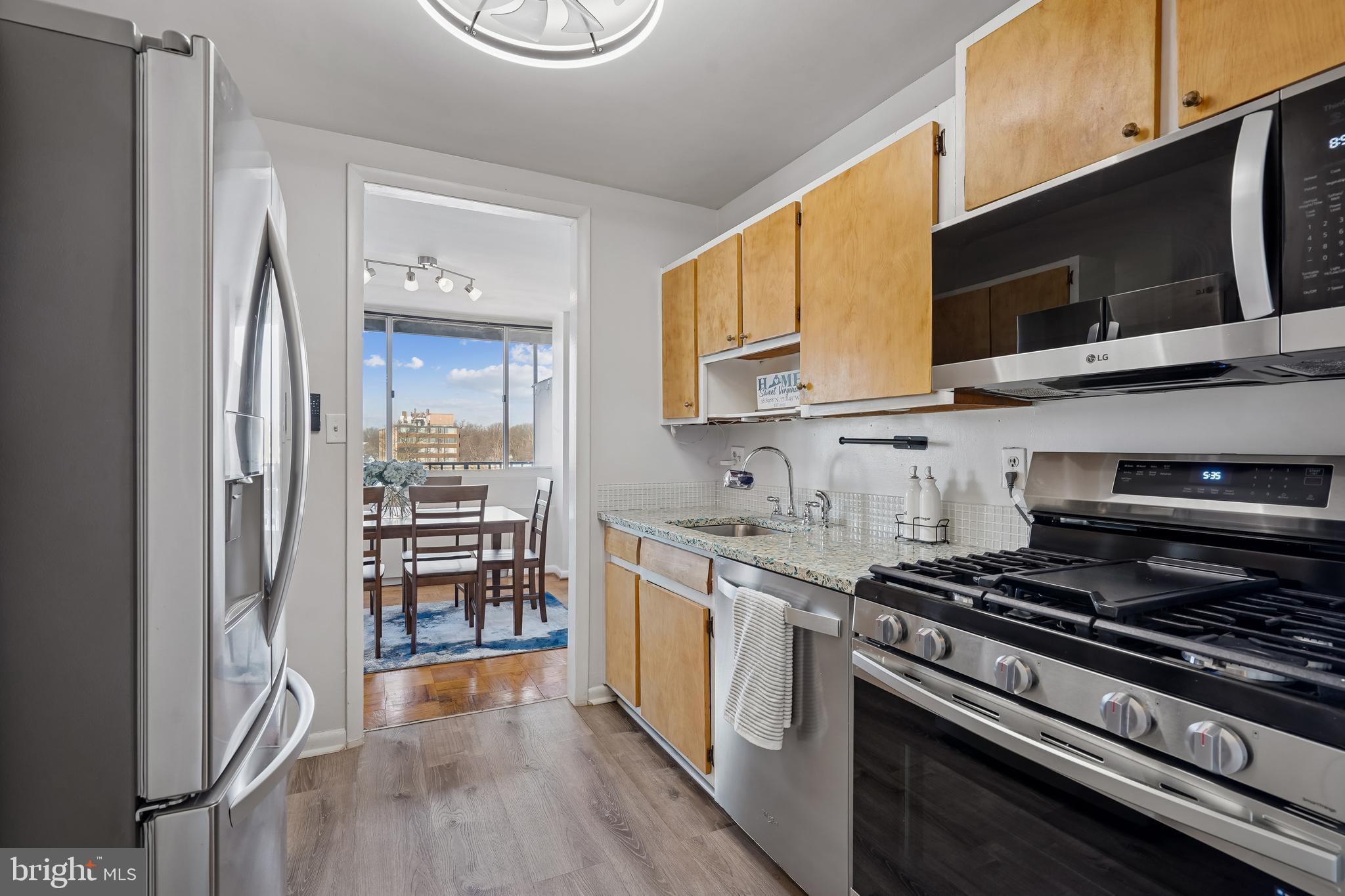 4343 Cherry Hill Road, Unit 705 Arlington, VA 22207 - Photo 3 of 41 a kitchen with stainless steel appliances a stove a microwave and a hard wood floor