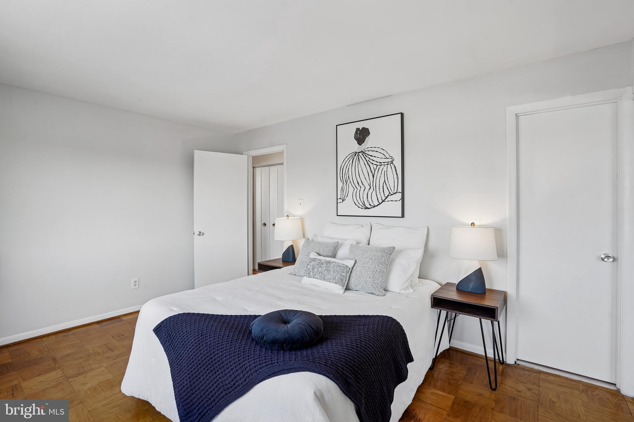 4343 Cherry Hill Road, Unit 705 Arlington, VA 22207 - Photo 4 of 41 a bedroom with a bed and a lamp