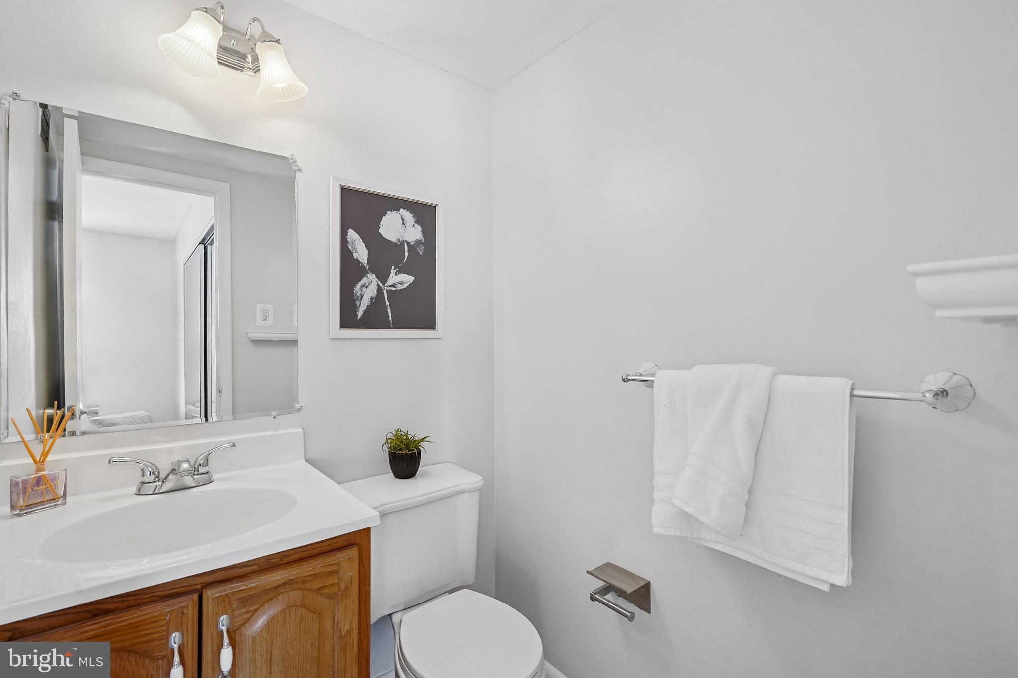 4343 Cherry Hill Road, Unit 705 Arlington, VA 22207 - Photo 7 of 41 a bathroom with a granite countertop sink mirror vanity and toilet