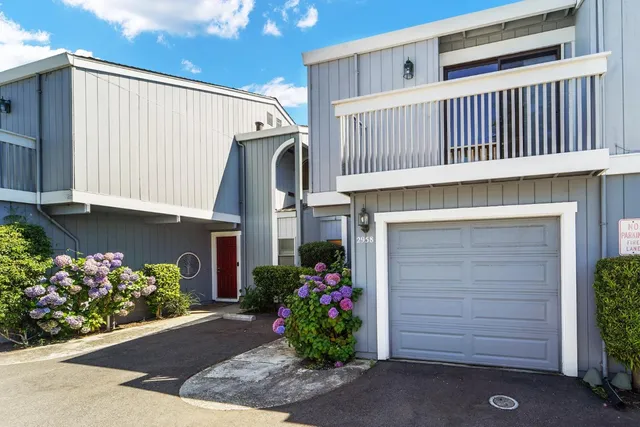 a view of a house with a yard and a garden